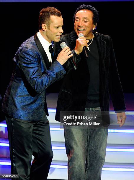 Singer Andrew Tierney of the Australian vocal group Human Nature sings with Motown legend Smokey Robinson during a performance after announcing a...