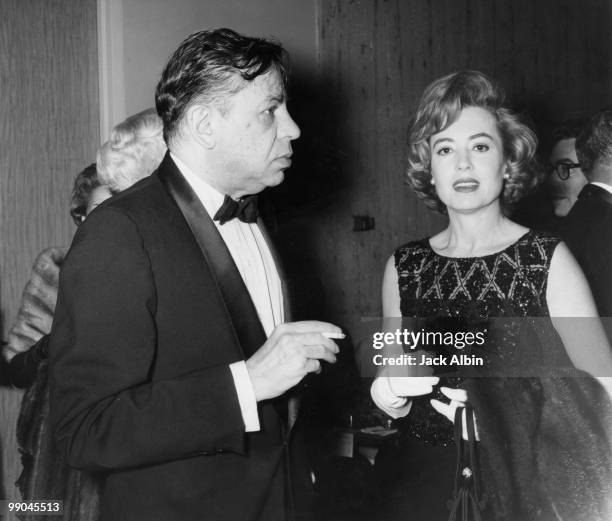 American pianist, composer and actor Oscar Levant with his wife, actress June Gale at a party, 1963.