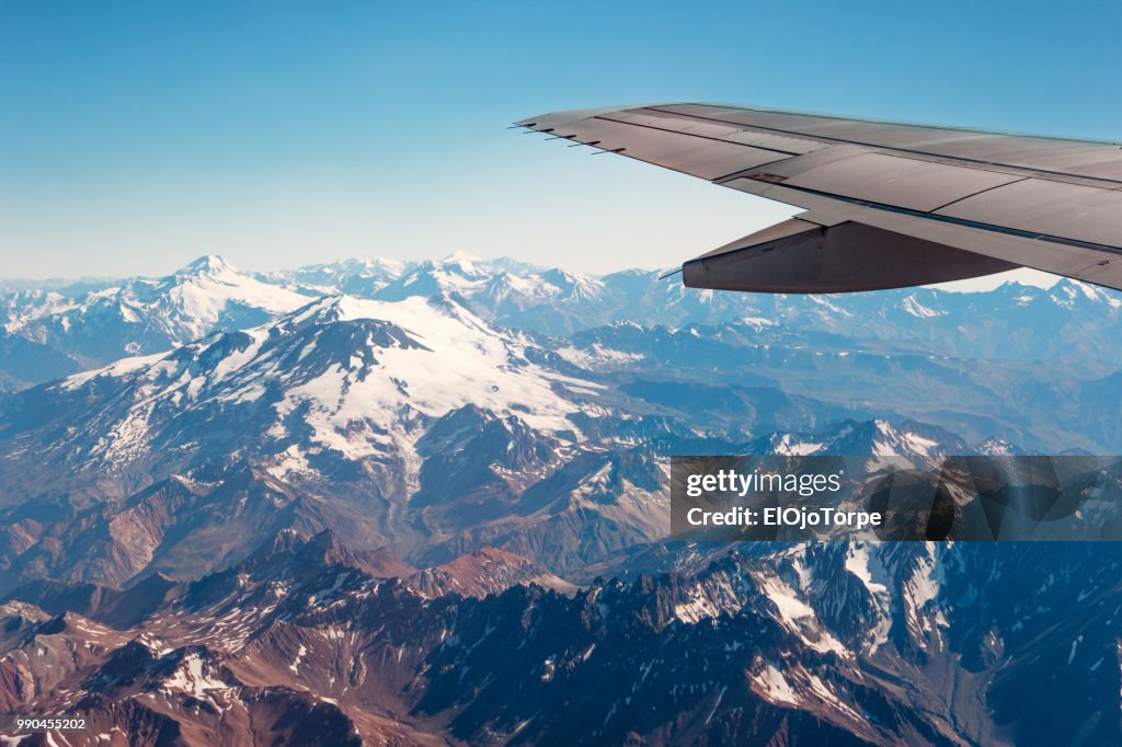 Flying over Andes mountains, view from window, Chile