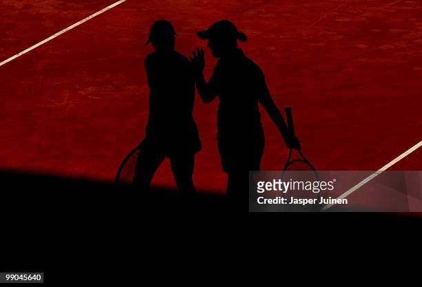 Liezel Huber of the USA chats with her doubles partner Anabel Medina Garrigues of Spain in their second round match against Chia-Jung Chuang of...