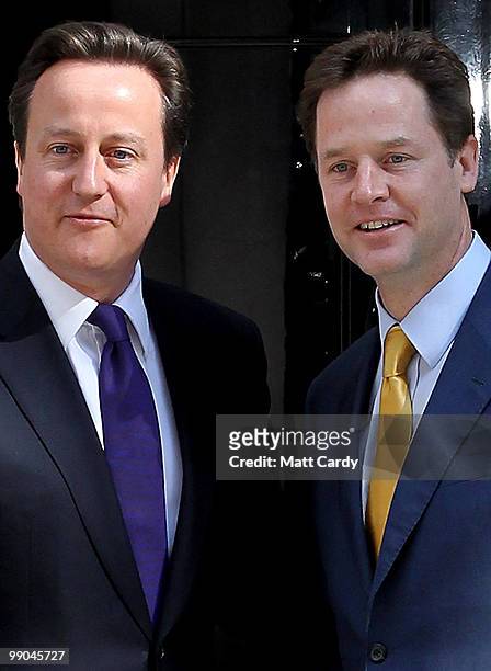 Prime Minister David Cameron greets Deputy Prime Minister Nick Clegg at the door of No. 10 Downing Street on May 12, 2010 in London, England. After a...
