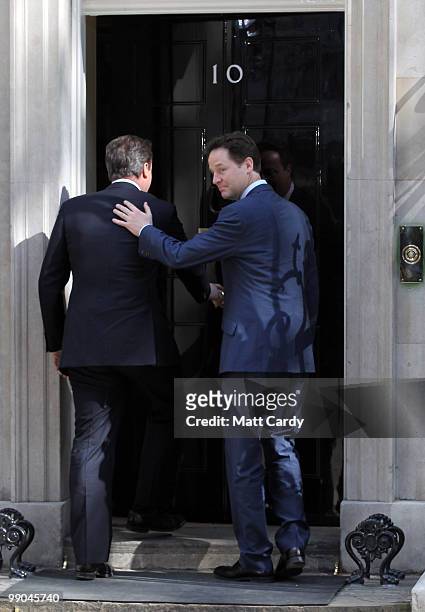 Prime Minister David Cameron greets Deputy Prime Minister Nick Clegg at the door of No. 10 Downing Street on May 12, 2010 in London, England. After a...