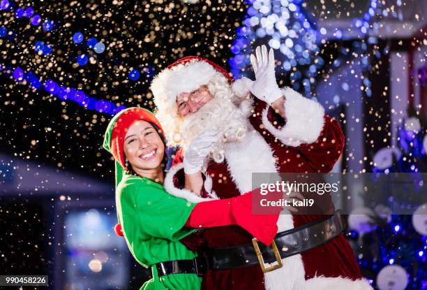 santa and elf at winter festival - santa waving stock pictures, royalty-free photos & images