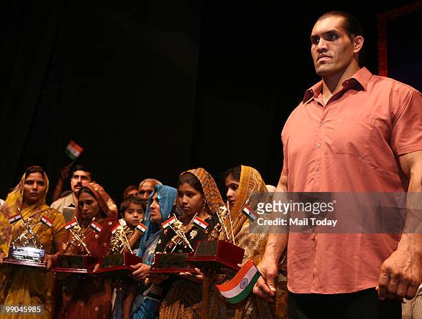 Wrestler The Great Khali with family members of a CRPF martyrs, who were killed in Dantewada, during Veer Rajiv Gandhi Bravery Awards function...