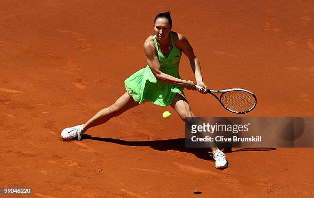 Jelena Jankovic of Serbia plays a backhand against Ana Ivanovic of Serbia in their second round match during the Mutua Madrilena Madrid Open tennis...