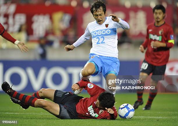 South Korea's Pohang Steelers forward No Byung Jun crashes with Japan's Kashima Antlers defender Daiki Iwamasa during their AFC Champions League...