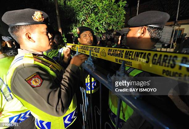 Indonesian police seal a raided house in Babakan Jati village in Cikampek, West Java province, on May 12, 2010 after shoot two suspects dead and...