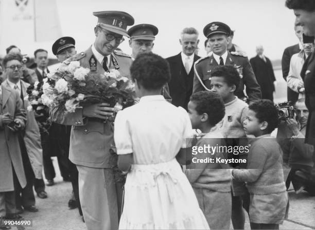 Group of children welcomes King Baudouin of Belgium on his arrival in Brussels after a visit to the Belgian Congo, 13th June 1955.