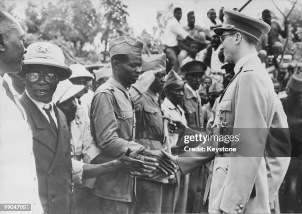 King Baudouin of Belgium shakes hands with local people on his arrival in Bukavu, Belgian Congo, 31st December 1959.