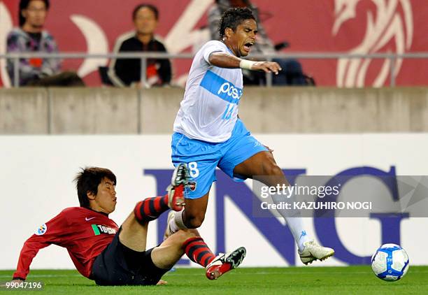 South Korea's Pohang Steelershis forward Almir is tackled by Japan's Kashima Antlers defender Toru Araiba during their AFC Champions League round 16...