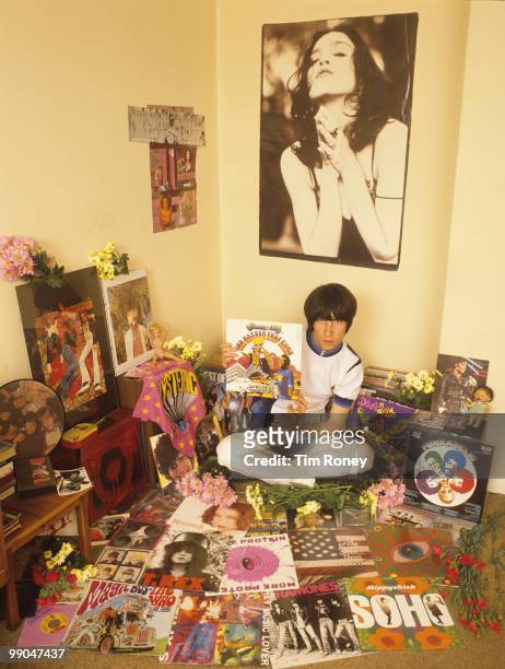 Bobby Gillespie, singer with pop group Primal Scream, pictured surrounded by music memorabilia, holding a copy of the 'The Harder They Come' LP, by...