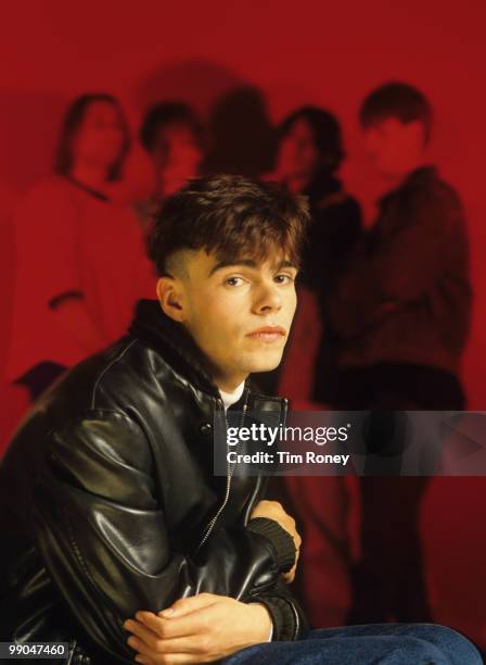 Tim Burgess, singer with pop group 'The Charlatans', with the rest of the band in the background, circa 1989.