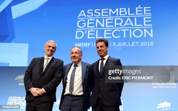 Candidates for the presidency of French employers' association Medef Alexandre Saubot and Geoffroy Roux de Bezieux pose with Medef president Pierre...