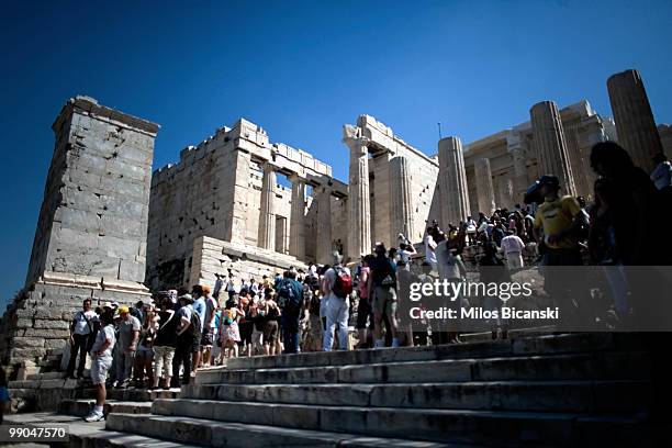 Tourists walk in front of the Propileon at the ancient Acropolis hill, one of the city's landmarks on May 11, 2010 in Athens, Greece. Greece's debt...