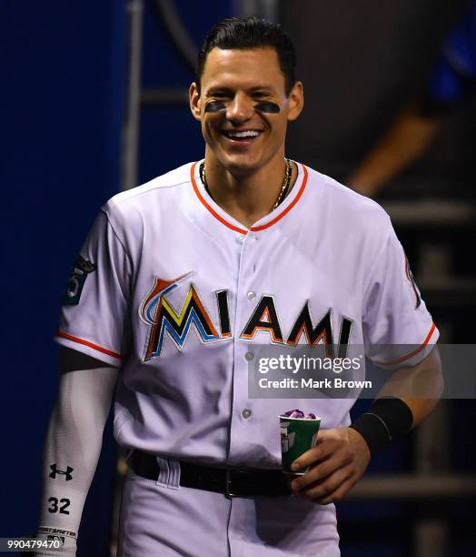 Derek Dietrich of the Miami Marlins laughing in the dugout before the game against the Arizona Diamondbacks at Marlins Park on June 28, 2018 in...