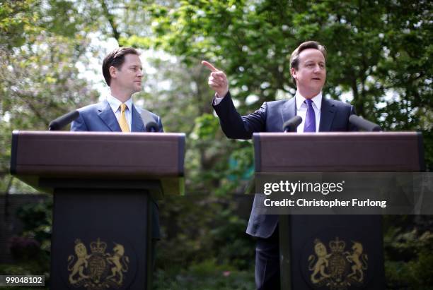 Prime Minister David Cameron and Deputy Prime Minister Nick Clegg hold their first joint press conference in the Downing Street garden on May 12,...