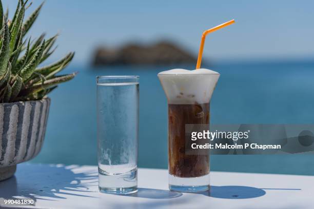 freddo cappuccino - iced cappuccino coffee drink served with water, lesvos, greece - freddo stock pictures, royalty-free photos & images