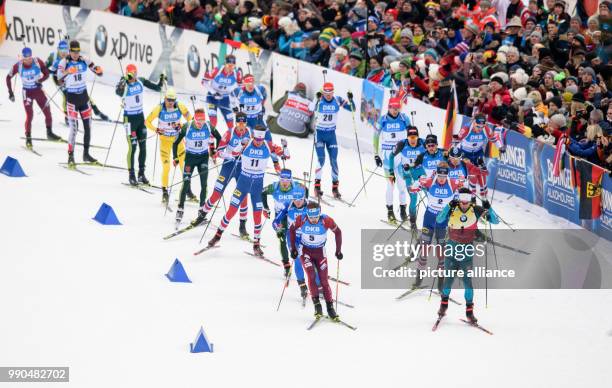 Martin Fourcade of France leads the field beside Anton Schipulin of Russia during the men's mass start event of the Biathlon World Cup at the...