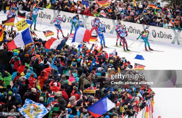Martin Fourcade of France leads the field beside Anton Schipulin of Russia during the men's mass start event of the Biathlon World Cup at the...