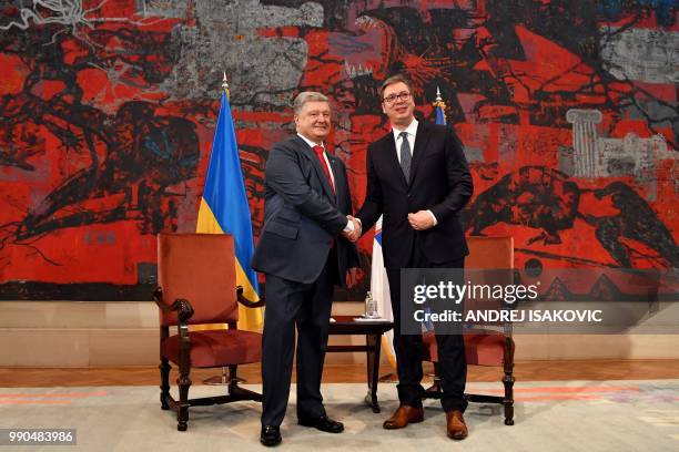 Serbian President Aleksandar Vucic shakes hands with his Ukrainian counterpart Petro Poroshenko during their meeting in Belgrade on July 3, 3018.