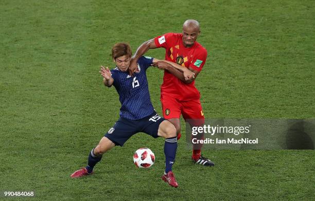 Yuya Osako of Japan vies with Vincent Kompany of Belgium during the 2018 FIFA World Cup Russia Round of 16 match between Belgium and Japan at Rostov...