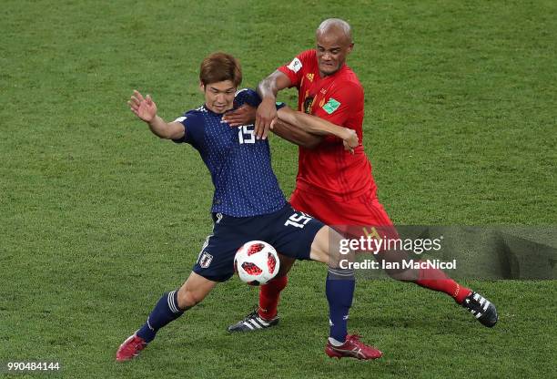 Yuya Osako of Japan vies with Vincent Kompany of Belgium during the 2018 FIFA World Cup Russia Round of 16 match between Belgium and Japan at Rostov...