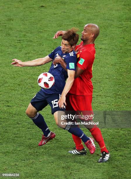 Yuya Osako of Japan vies with Vincent Kompany of Belgium during the 2018 FIFA World Cup Russia Round of 16 match between Belgium and Japan at Rostov...