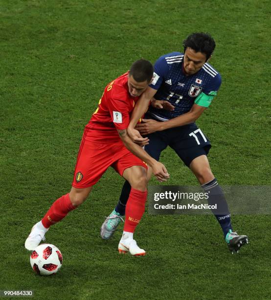 Eden Hazard of Belgium vies with Makoto Hasebe of Japan during the 2018 FIFA World Cup Russia Round of 16 match between Belgium and Japan at Rostov...