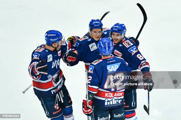 Mannheim's David Wold , goalkeeper Luke Adam, Chad Kolarik and Carlo Colaiacovo celebrate Adam's goal at the SAP-Arena in Mannheim, Germany, 14...