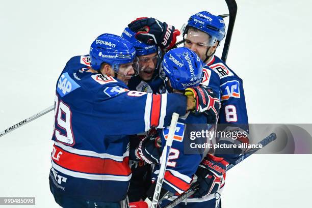 Mannheim's David Wold , goalkeeper Luke Adam, Chad Kolarik and Carlo Colaiacovo celebrate Adam's goal at the SAP-Arena in Mannheim, Germany, 14...