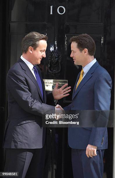 David Cameron, U.K. Prime minister, left, greets Nick Clegg, U.K. Deputy prime minister, on the steps of 10 Downing Street, in London, U.K., on...