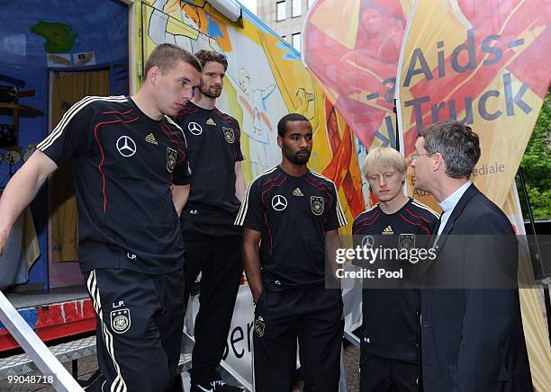 President of Missio Klaus Kraemer talks to players of team Germany Lukas Podolski, Arne Friedrich, Cacau and Andreas Beck during their visit of the...
