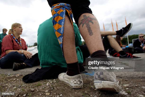 Volunteer with a cross tattooed on his leg waits for the opening ceremony of the 2nd Ecumenical Church Day on May 12, 2010 in Munich, Germany....