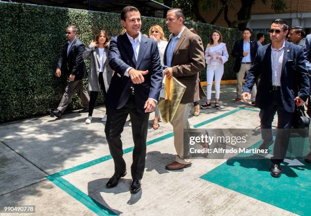 President Enrique Peña Nieto gestures after casting his vote during the 2018 Presidential Elections at Escuela Primaria El Pípila on July 1, 2018 in...