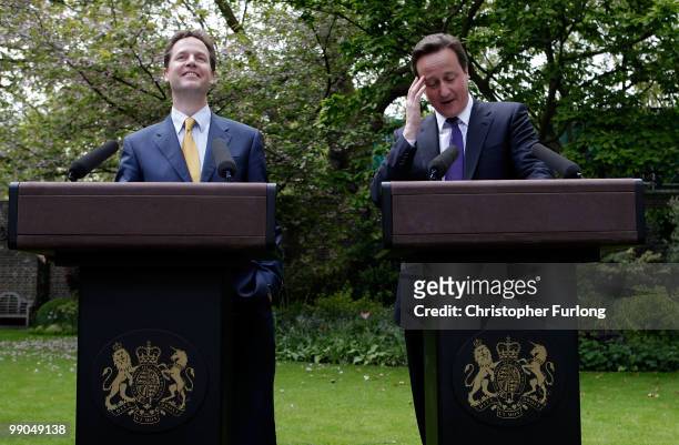 Prime Minister David Cameron and Deputy Prime Minister Nick Clegg share a joke as they hold their first joint press conference in the Downing Street...