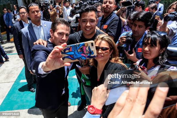 President Enrique Peña Nieto takes a selfie with Mexican citizens after casting his vote during the 2018 Presidential Elections at Escuela Primaria...