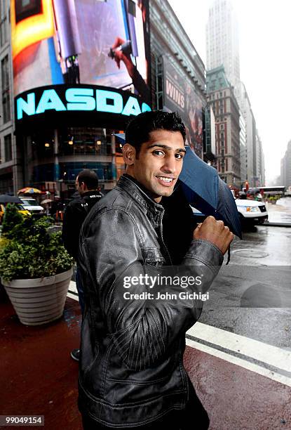 Amir Khan poses in front of the NASDAQ building ahead of his WBA title fight against Paulie Malignaggi on May 12, 2010 in Times Square, in New York...