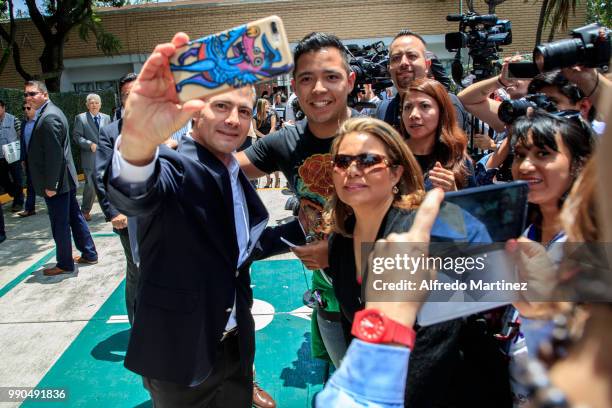 President Enrique Peña Nieto takes a selfie with Mexican citizens after casting his vote during the 2018 Presidential Elections at Escuela Primaria...