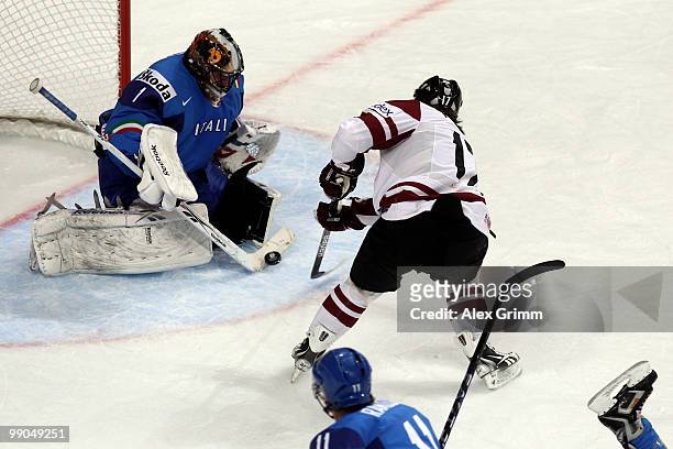 Goalkeeper Adam Russo of Italy makes a save against Aleksandrs Nizivijs of Latvia during the IIHF World Championship group C match between Italy and...