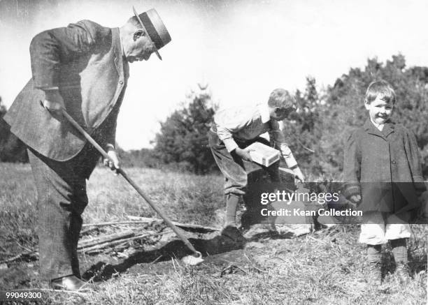 President Grover Cleveland gardening at his summer home in Tamworth, New Hampshire, USA, circa 1900.