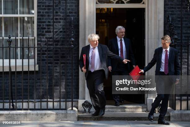 Foreign Secretary Boris Johnson, Brexit Secretary David Davis and Britain's Defence Secretary Gavin Williams leave Downing Street after the weekly...