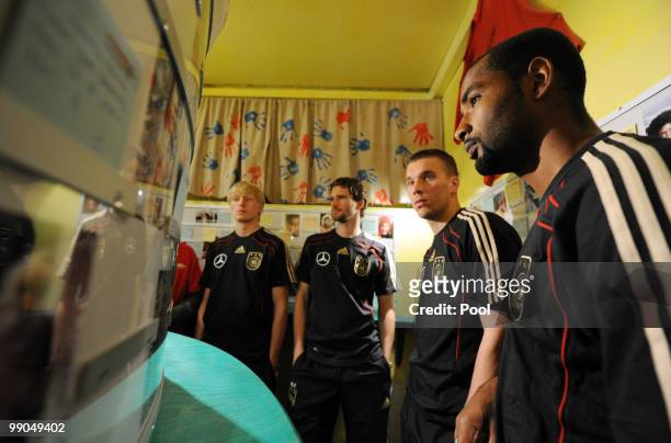 Players of team Germany Cacau, Lukas Podolski, Arne Friedrich and Andreas Beck visit the Missio-Aidstruck on May 12, 2010 in Duesseldorf, Germany....