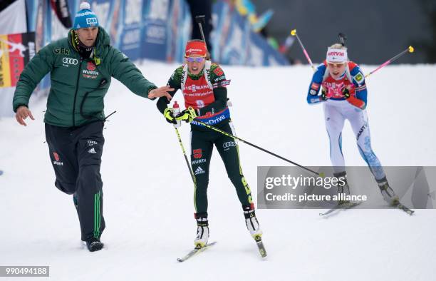 Kaisa Maekaeraeinen of Finland and Laura Dahlmeier of Germany at the finish line during the women's mass start event of the Biathlon World Cup at the...