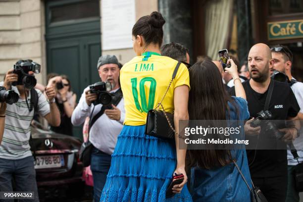 Brazilian super model Adriana Lima wears a "Lima" Brasil soccer/football jersey during Couture Fall 2018 Fashion Week on July 2, 2018 in Paris,...