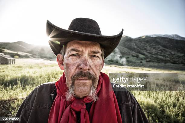 wanted western outlaw in black cowboy hat - villain stock pictures, royalty-free photos & images