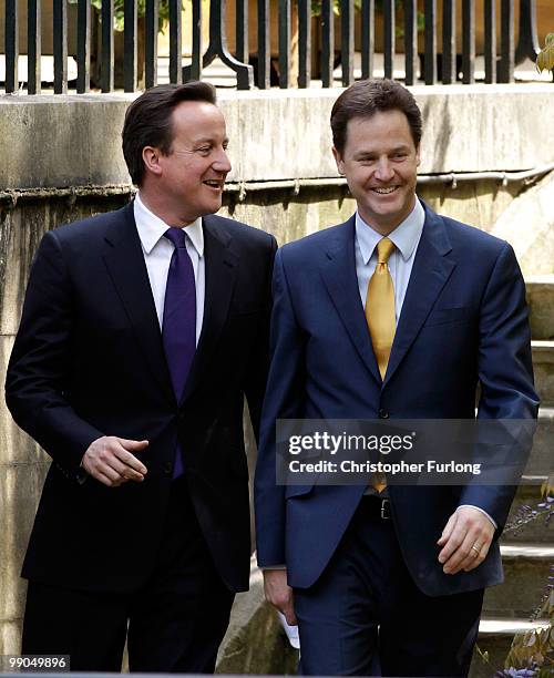 Prime Minister David Cameron and Deputy Prime Minister Nick Clegg arrive for their first joint press conference in the Downing Street garden on May...