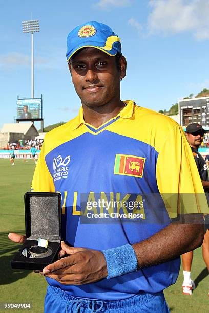 Angelo Mathews of Sri Lanka poses with his man of the match award after the ICC World Twenty20 Super Eight match between West Indies and Australia at...