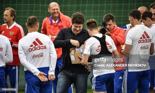 Russian classical pianist Denis Matsuev presents his CD to the players of the Russian national team during a visit to a training session in Novogorsk...