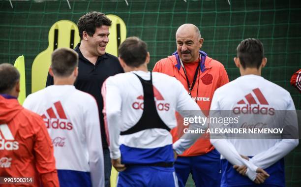 Famous Russian pianist Denis Matsuev and Russia's coach Stanislav Cherchesov talk to the players of the Russian national team during a visit, by...