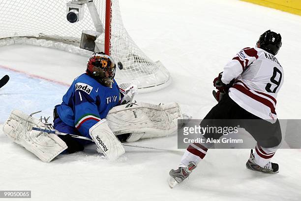Marins Karsums of Latvia tries to score against goalkeeper Adam Russo of Italy during the IIHF World Championship group C match between Italy and...